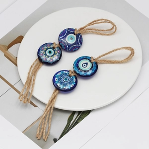 Set of four blue evil eye pendants with mandala patterns and rustic hemp rope details