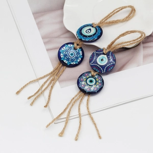 Detailed close-up of Bohemian Evil Eye mandala charms with natural jute rope and tassels
