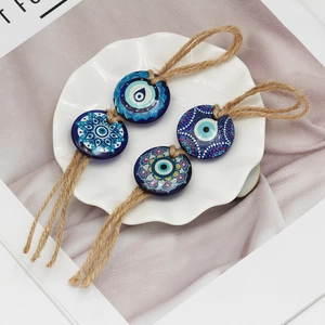 Handmade evil eye hanging ornaments with blue glass mandala patterns and hemp rope