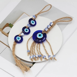 Blue glass evil eye wall hanging with natural jute rope and floral ceramic beads