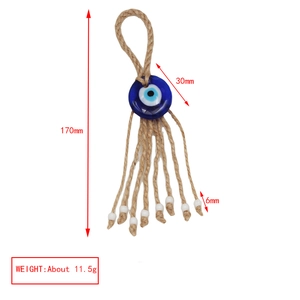 Detail of blue evil eye pendant with rustic hemp rope tassel and white beads