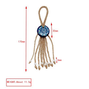 Detail of bohemian evil eye pendant with natural hemp rope tassel and beads, 170mm length