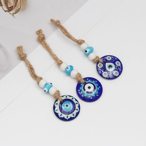 Detailed view of handmade Evil Eye amulets with braided hemp ropes and floral patterns