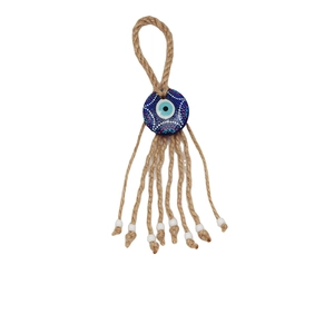 Macro detail of Evil Eye pendant with braided hemp rope and small white beads decoration