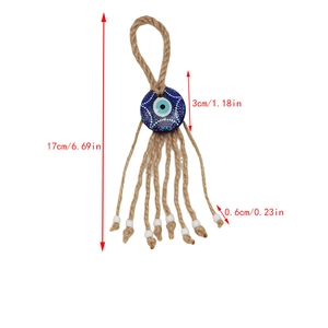 Detailed view of handmade Evil Eye charm with brown hemp rope and white beads