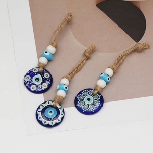 Three pieces of blue evil eye wall hanging decor with hemp rope and beaded detail