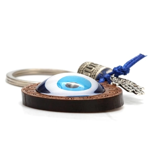 Evil Eye wooden keychain with blue glass pendant and silver Hamsa hand charm accessory