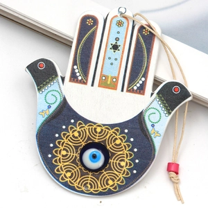 Detail of wooden Hamsa hand pendant featuring Evil Eye motif and Star of David symbol