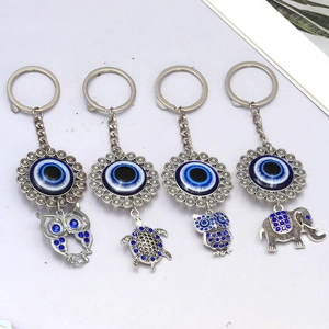 Silver evil eye keychain set with elephant owl and turtle charms in blue crystal