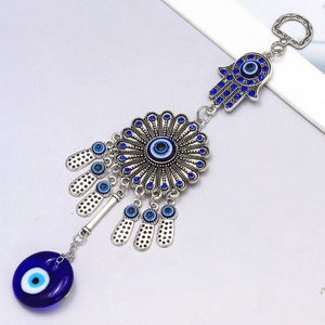 Vintage Hamsa Hand and Evil Eye keychain pendant with blue rhinestones on white background