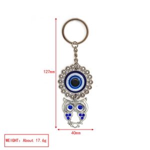 Detailed size view of silver owl evil eye keychain featuring blue enamel and rhinestones
