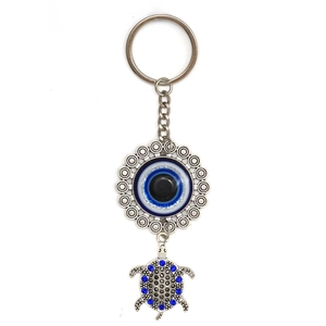 Detailed shot of silver tortoise keychain with blue evil eye pendant and crystal shell