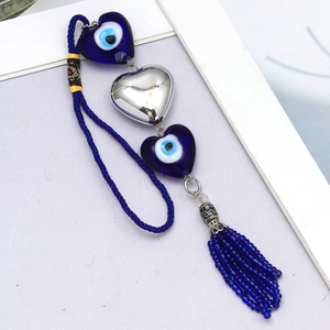Blue heart-shaped evil eye pendant with braided rope and tassel for car or home decor