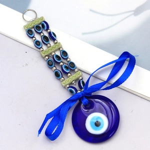 Detail of Turkish Evil Eye keychain with blue glass pendant and decorative beads