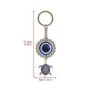 Detail of Turkish evil eye and blue rhinestone turtle keychain showing dimensions