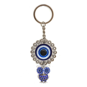 Detail view of silver owl keychain with deep blue rhinestones and Nazar evil eye charm