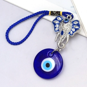 Detailed view of the Evil Eye elephant pendant with blue enamel and braided rope