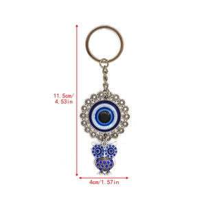 Detailed size view of silver owl keychain with evil eye and blue rhinestones