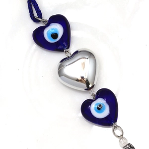 Blue heart evil eye keychain pendant with silver accent and braided blue cord hanging