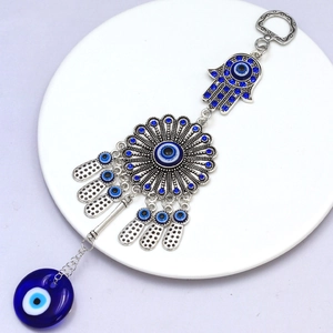 Detailed view of silver Hamsa hand keychain with blue Evil Eye and sparkling rhinestones