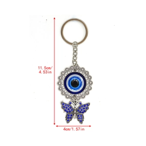Detailed view of evil eye butterfly keychain with blue rhinestones and size dimensions