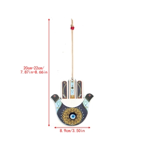 Detailed view of wooden Hamsa Hand wall hanging with Evil Eye and Star of David