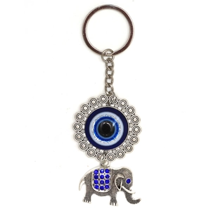 Close-up of Turkish evil eye charm with intricate silver elephant pendant and blue crystals