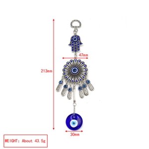 Detailed view of silver Hamsa hand and blue Evil Eye charm with precise measurements