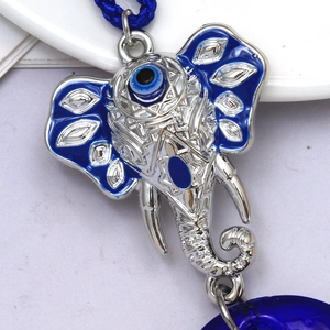 Elephant evil eye keychain pendant with blue enamel and woven rope for protection