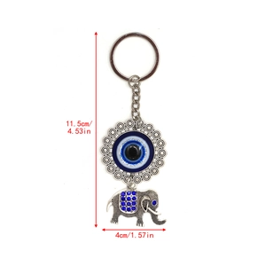 Detail view of evil eye elephant keychain with blue rhinestones and dimensions shown