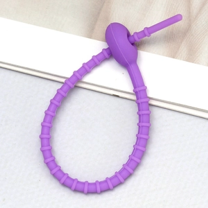 Detail view of the flexible purple silicone cable tie with adjustable locking mechanism