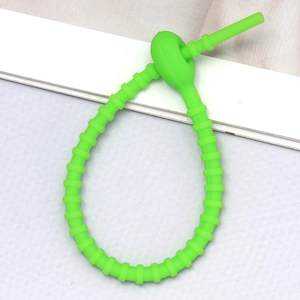 Detail of neon green silicone adjustable strap with anti-slip texture and circular buckle