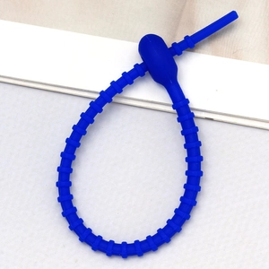 Detail of royal blue silicone cable tie with adjustable notched design for securing accessories
