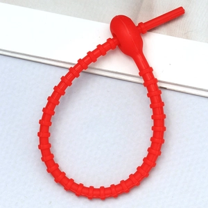 Close-up of adjustable red silicone strap with a functional multi-segment buckle design