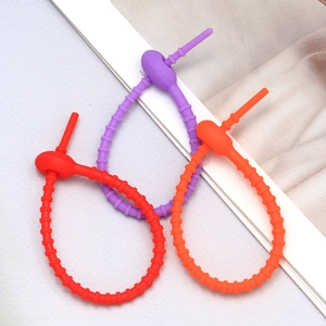 Detail view of colorful silicone cable ties with non-slip gear design for cord management