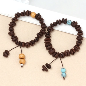 Detail of coffee bean beaded bracelets with evil eye accents and elegant tassels
