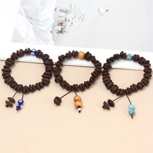 Detailed view of coffee bean bead bracelets featuring lucky evil eye and turquoise stones