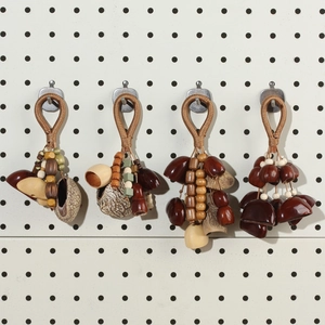 Macro detail of handmade natural nut shells and polished wood beads on woven rope