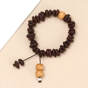 Detailed close-up of handmade coffee bean bracelet with wooden beads and woven cord