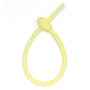 Close-up of yellow silicone keychain strap with adjustable teeth and evil eye charm
