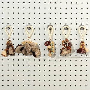 Detailed view of handmade nut shell pendants with woven rope and natural beads