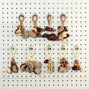 Handcrafted nut shell charms with woven ropes and wooden beads in diverse ethnic styles