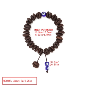 Detail of coffee bean beads and blue evil eye charms with adjustable braided cord
