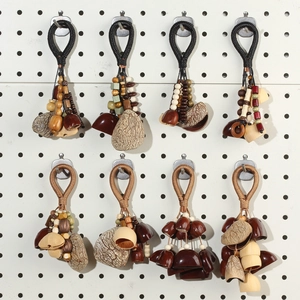 Detail of eight handcrafted ethnic style keychains with natural seed shells and wooden beads