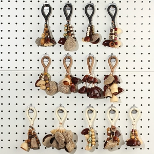 Detailed view of handmade ethnic style pendants with natural seed husks and woven cords