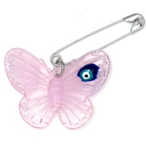 Detail of pink resin butterfly brooch with blue evil eye bead and silver safety pin