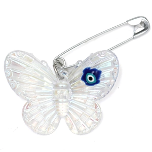 Macro detail of acrylic butterfly brooch with evil eye charm and iridescent wing texture