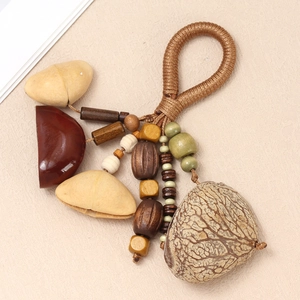 Detailed macro view of handmade ethnic nut shell pendant with wooden beads and woven rope