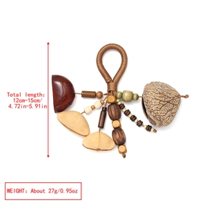 Macro detail of handmade nut shell keychain with woven rope and natural wood beads