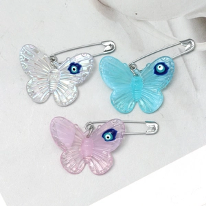 Three-piece acrylic butterfly brooch set with evil eye charm in white, blue, and purple